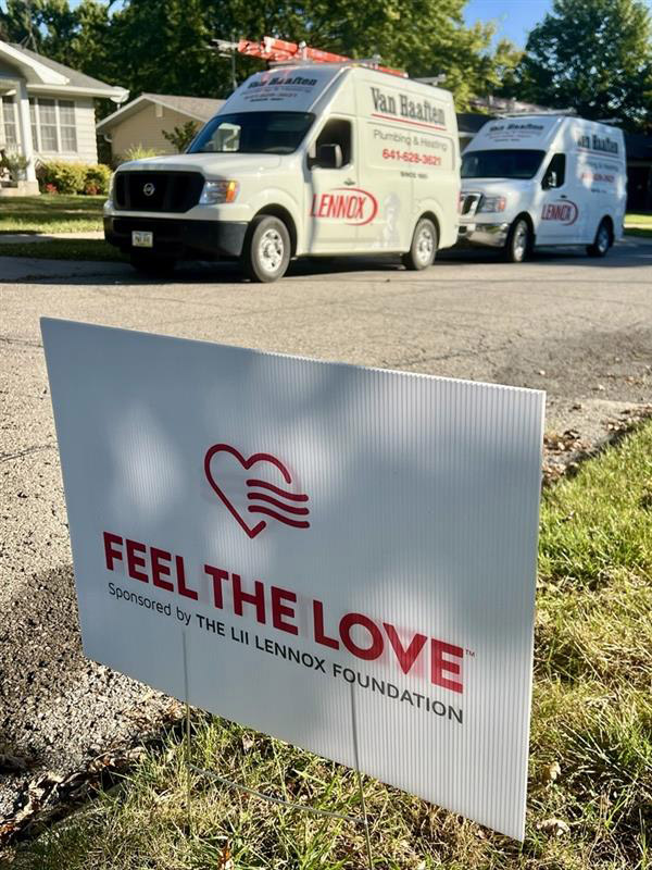 Feel the Love sign in a year with the Van Haaften truck in the background